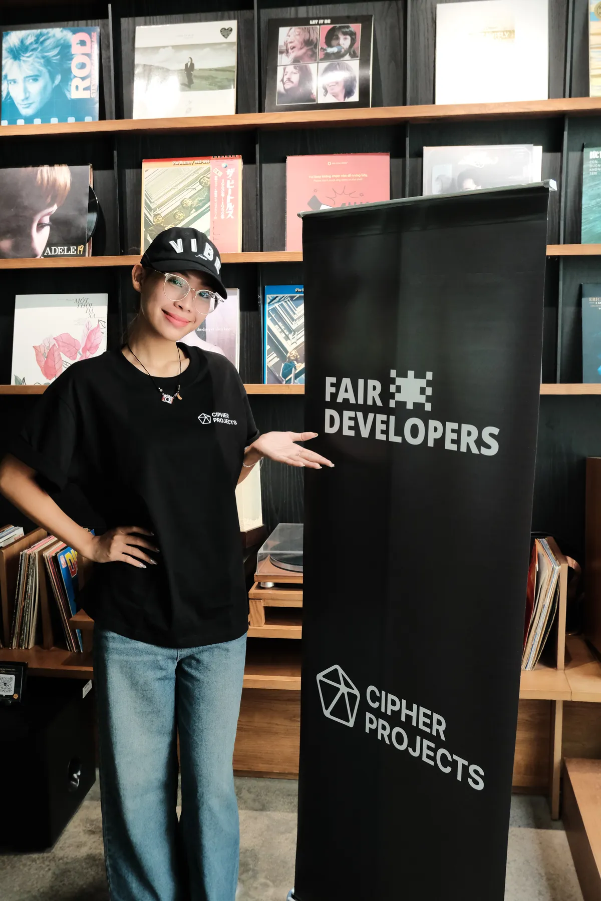 A speaker presenting beside the Cipher Projects banner